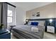Stylish bedroom features a gray striped bed, blue accents, and modern decor for a comfortable and chic retreat at 6165 Carrier Dr # 3701, Orlando, FL 32819