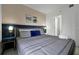 Stylish bedroom featuring a comfortable bed, elegant bedside decor, and an en-suite bathroom at 6165 Carrier Dr # 3701, Orlando, FL 32819