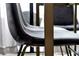 Close-up of a gray upholstered chair with sleek metal legs, showcasing its modern design and comfort at 6165 Carrier Dr # 3701, Orlando, FL 32819