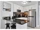 Contemporary kitchen with white cabinets, stainless steel appliances, and bar seating at 6165 Carrier Dr # 3701, Orlando, FL 32819