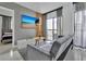 Comfortable living room featuring a gray sofa and a view from the balcony at 6165 Carrier Dr # 3701, Orlando, FL 32819