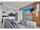 Modern living room with a gray sofa and flat screen television at 6165 Carrier Dr # 3701, Orlando, FL 32819