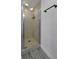 Modern bathroom with a glass-enclosed shower featuring marble-look tile, showcasing a clean and stylish design at 6165 Carrier Dr # 3701, Orlando, FL 32819