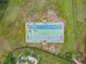 Aerial view of shuffleboard courts surrounded by lush landscaping, near a community pool and seating area at 619 Lake Marion Golf Resort, Kissimmee, FL 34759
