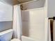 Well-maintained bathroom with a toilet and shower-tub combination with white tiling at 619 Lake Marion Golf Resort, Kissimmee, FL 34759
