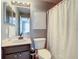 Nicely appointed bathroom featuring a vanity, toilet, and shower-tub combination with a white curtain at 619 Lake Marion Golf Resort, Kissimmee, FL 34759