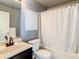 Modern bathroom with a vanity, toilet, and shower-tub combination with a white curtain at 619 Lake Marion Golf Resort, Kissimmee, FL 34759
