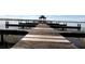 Picturesque view of a wooden dock extending into a serene lake, perfect for leisurely strolls at 619 Lake Marion Golf Resort, Kissimmee, FL 34759