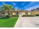 Charming single-story home with a well-manicured lawn and tropical landscaping at 619 Lake Marion Golf Resort, Kissimmee, FL 34759