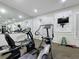 Community gym featuring cardio machines and wall-mounted television, perfect for fitness enthusiasts at 619 Lake Marion Golf Resort, Kissimmee, FL 34759