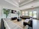 Bright lounge area with comfortable seating, television, plants, and ample natural light at 619 Lake Marion Golf Resort, Kissimmee, FL 34759
