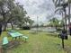 Picnic area features green tables and a grill, perfect for outdoor gatherings and barbecues by the pool at 619 Lake Marion Golf Resort, Kissimmee, FL 34759