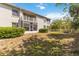 Exterior view of the building with a balcony and screened in patio, overlooking the private backyard at 640 Cranes Way # 164, Altamonte Springs, FL 32701