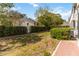 Private backyard featuring well-maintained greenery, brick patio, and lush hedges at 640 Cranes Way # 164, Altamonte Springs, FL 32701