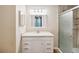 Bathroom featuring single sink vanity with storage and a glass door shower with wooden style paneling at 640 Cranes Way # 164, Altamonte Springs, FL 32701