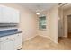 Sunny breakfast nook with tiled floors, white cabinets, and a window offering natural light at 640 Cranes Way # 164, Altamonte Springs, FL 32701