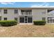 Exterior building view of enclosed patios on a sunny day with green landscaping at 640 Cranes Way # 164, Altamonte Springs, FL 32701