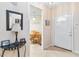 Inviting foyer with tile flooring, leading to a dining area with a wooden table and chairs at 640 Cranes Way # 164, Altamonte Springs, FL 32701