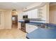 Well-lit kitchen with stainless steel appliances, white cabinetry, and blue countertops at 640 Cranes Way # 164, Altamonte Springs, FL 32701