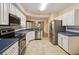 Modern kitchen with white cabinetry, stainless steel appliances, and tiled flooring at 640 Cranes Way # 164, Altamonte Springs, FL 32701