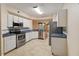 Bright kitchen featuring stainless steel appliances, white cabinets and a view into the living area at 640 Cranes Way # 164, Altamonte Springs, FL 32701