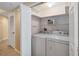 Convenient laundry closet featuring a washer and dryer with ample shelving for organized storage at 640 Cranes Way # 164, Altamonte Springs, FL 32701