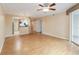 Open-concept living room with wood floors, seamlessly flowing into the kitchen area with stainless appliances at 640 Cranes Way # 164, Altamonte Springs, FL 32701