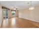 Spacious open-concept living room with gleaming hardwood floors and a sliding glass door to the patio at 640 Cranes Way # 164, Altamonte Springs, FL 32701