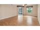 Bright living room with wood floors, sliding glass doors, and a window offering ample natural light at 640 Cranes Way # 164, Altamonte Springs, FL 32701
