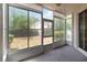 An enclosed back patio with large windows overlooks a grassy yard and landscaping at 640 Cranes Way # 164, Altamonte Springs, FL 32701