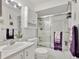 Bathroom featuring a glass shower door, white walls, and purple towels at 704 Pinnacle Dr, Haines City, FL 33844