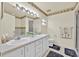 Bathroom featuring double sinks, a well-lit mirror, and a glass shower door at 704 Pinnacle Dr, Haines City, FL 33844