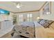 Bedroom featuring a ceiling fan, tile flooring, and a large flat screen television at 704 Pinnacle Dr, Haines City, FL 33844