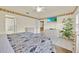 Bright bedroom with ceiling fan, tile flooring, and a flat screen television at 704 Pinnacle Dr, Haines City, FL 33844