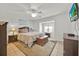 Bedroom featuring a ceiling fan, a window, and a decorative trunk at 704 Pinnacle Dr, Haines City, FL 33844