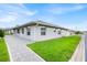 Side view of single-story home with well-maintained lawn and walkway at 704 Pinnacle Dr, Haines City, FL 33844