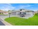 Charming single-story home featuring a well-manicured lawn and a cozy outdoor seating area at 704 Pinnacle Dr, Haines City, FL 33844