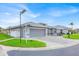 Well-maintained single-story home with a paved driveway and a two-car garage at 704 Pinnacle Dr, Haines City, FL 33844