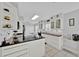 Well-lit kitchen with white cabinets, dark countertops, and tile flooring at 704 Pinnacle Dr, Haines City, FL 33844