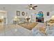 Cozy living room featuring tile floors, ceiling fan, and a fireplace at 704 Pinnacle Dr, Haines City, FL 33844