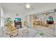Sunroom featuring tile floors, white walls, comfortable seating, and access to living room at 704 Pinnacle Dr, Haines City, FL 33844