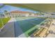 Community shuffleboard court area with benches and covered seating, showcasing a recreational lifestyle at 704 Pinnacle Dr, Haines City, FL 33844
