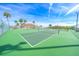 Tennis courts in a community featuring palm trees and benches at 704 Pinnacle Dr, Haines City, FL 33844