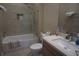 Modern bathroom featuring decorative tiling, a glass enclosed tub/shower, and a sink vanity at 7465 Bleecker Ln, Kissimmee, FL 34747