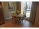 Dining area with modern decor, wooden table set for four, and natural light from a large window at 7465 Bleecker Ln, Kissimmee, FL 34747