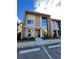 Modern townhome featuring clean architectural lines, a private entrance, and lush landscaping at 7465 Bleecker Ln, Kissimmee, FL 34747