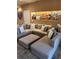 Cozy living room featuring a sectional couch with decorative pillows and modern art on the walls at 7465 Bleecker Ln, Kissimmee, FL 34747