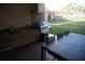Outdoor kitchen with a built-in grill, sink, and a dining table for outdoor entertaining at 7465 Bleecker Ln, Kissimmee, FL 34747