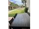 An outdoor patio with a large dining table, overlooking a courtyard with manicured green space at 7465 Bleecker Ln, Kissimmee, FL 34747