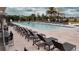 Resort-style swimming pool surrounded by lounge chairs, palm trees, and residential buildings at 7465 Bleecker Ln, Kissimmee, FL 34747